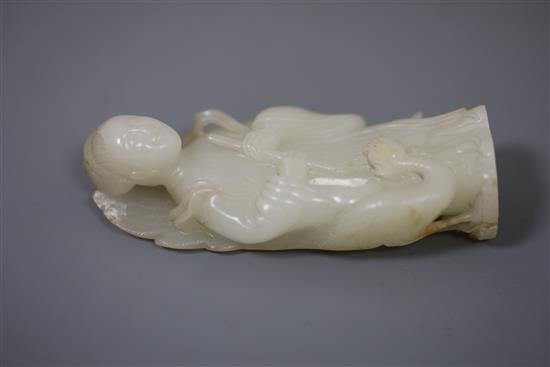 A fine Chinese white and russet jade group of Xi Wangmu and a phoenix, 19th/20th century, 9.5cm high, wood stand